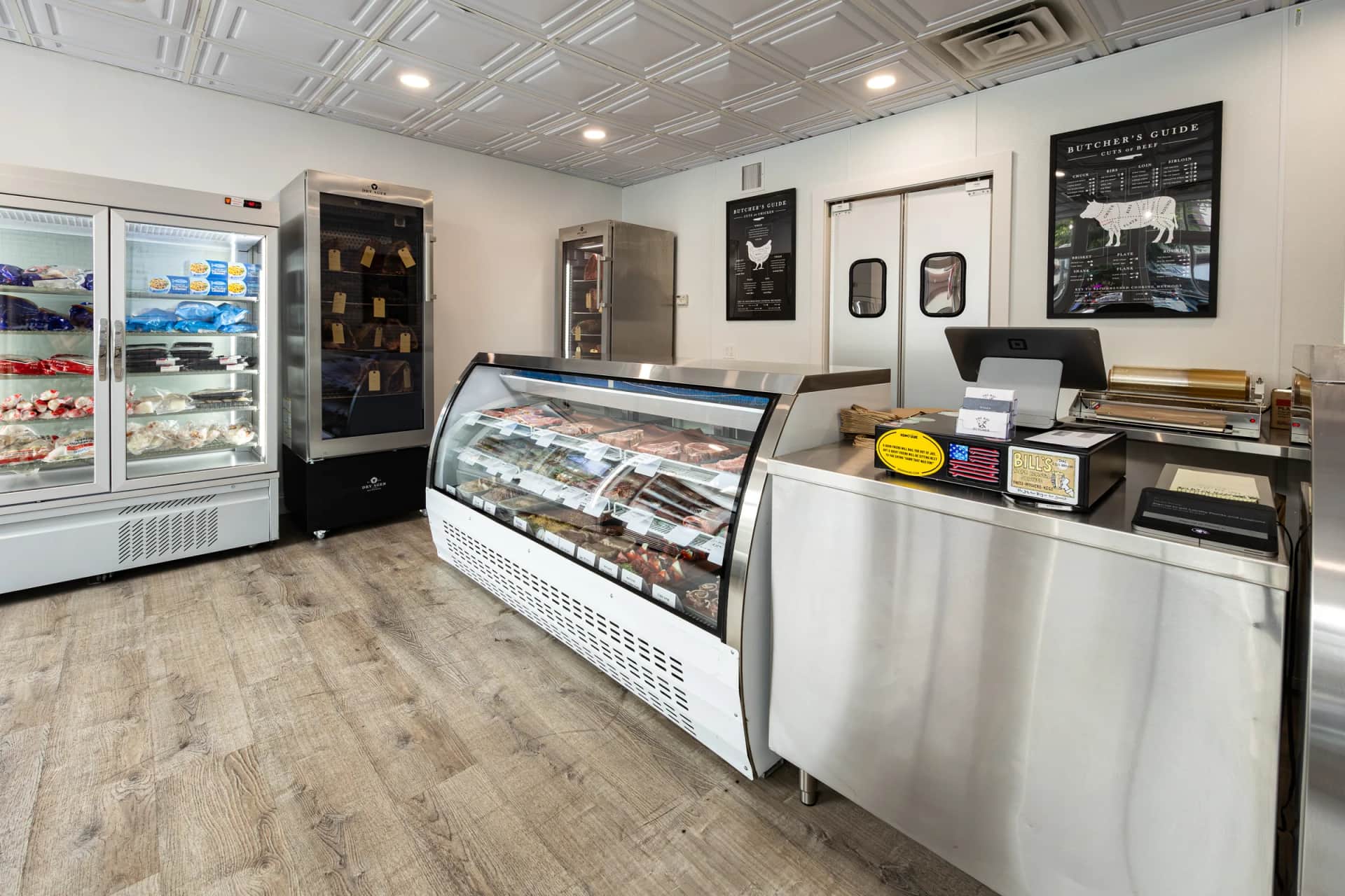 The Bay Butcher shop floor showing the counter case and knife wall