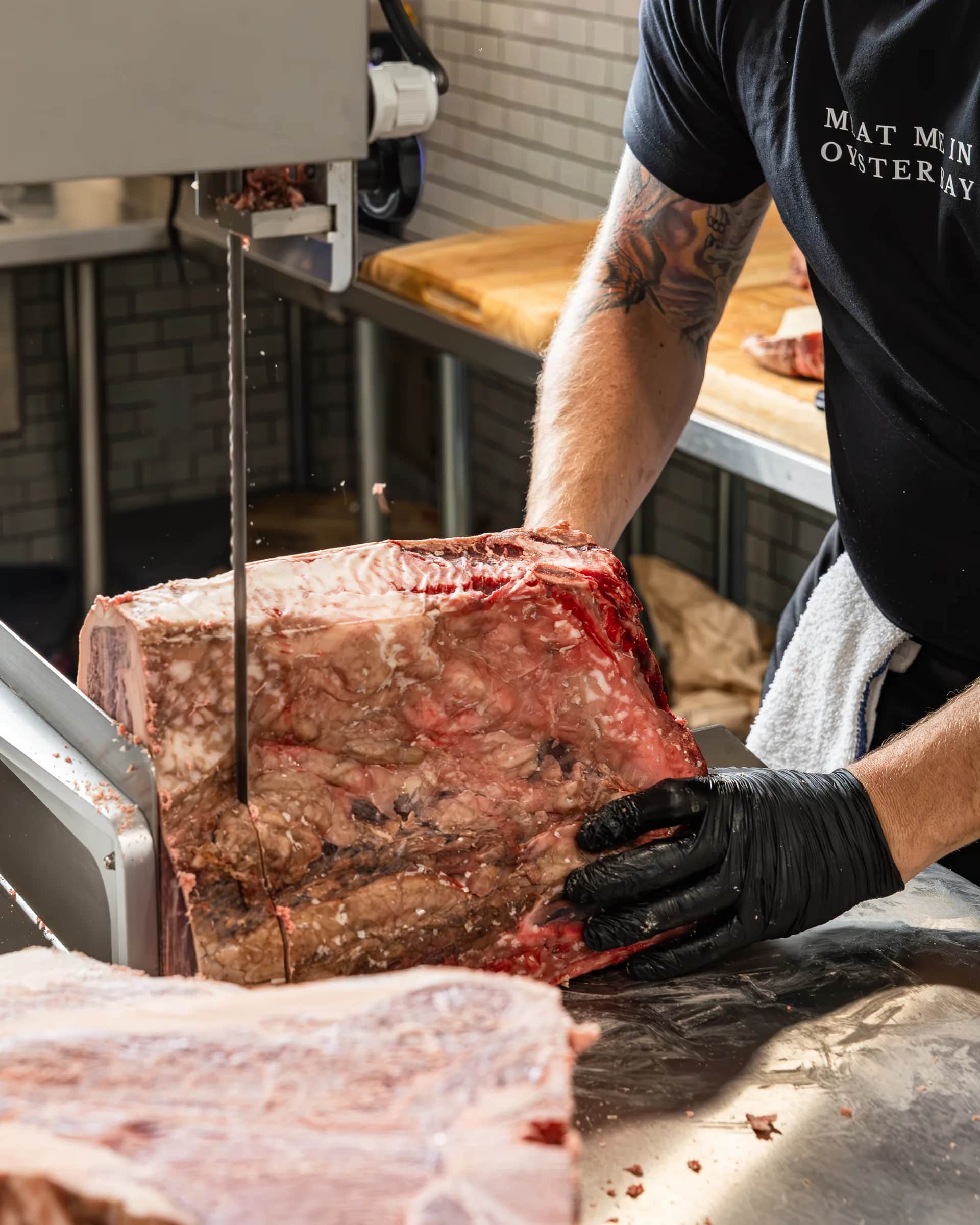 Band saw cutting through a beef primal