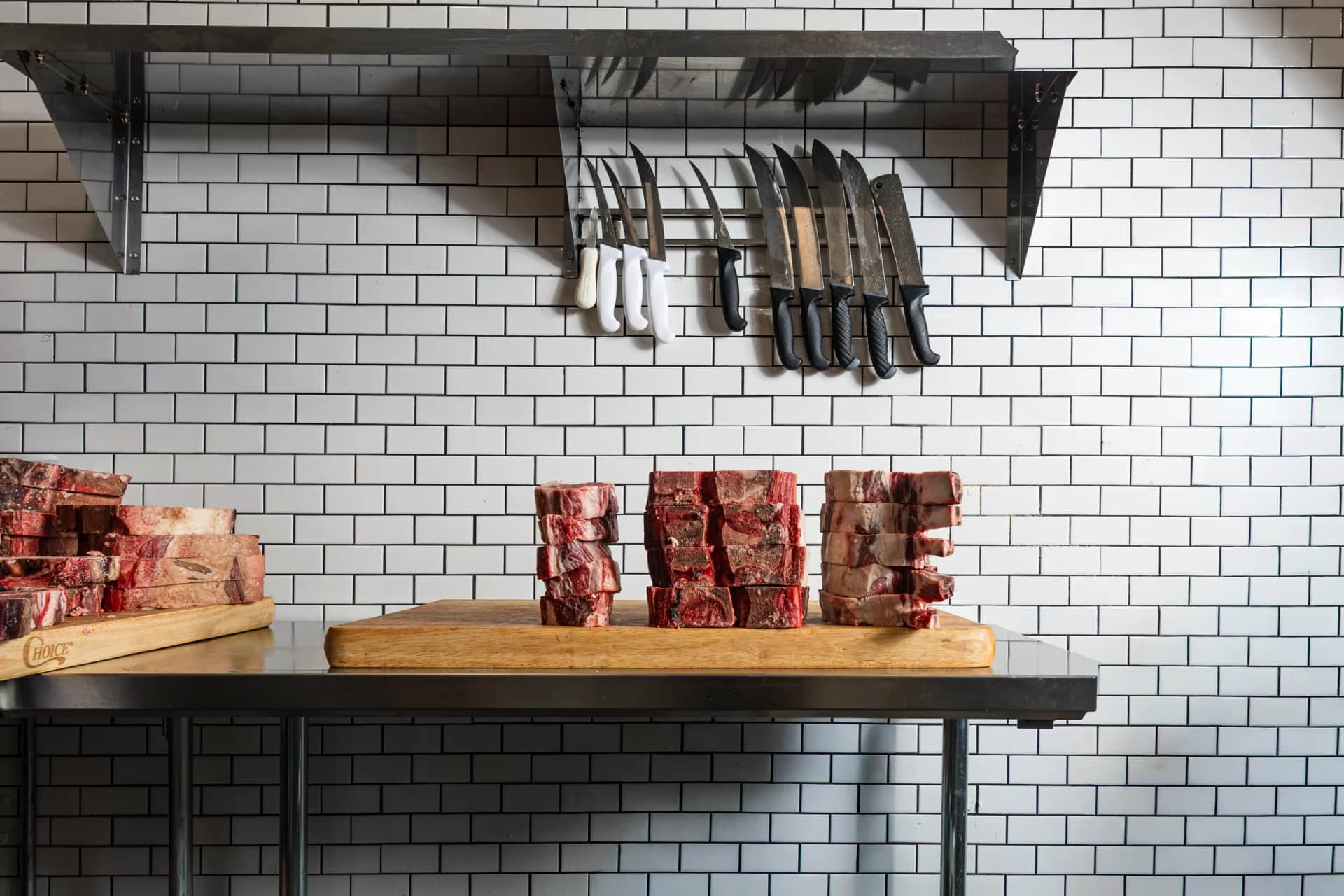 Shop shelf with the knife rack and stacks of steaks