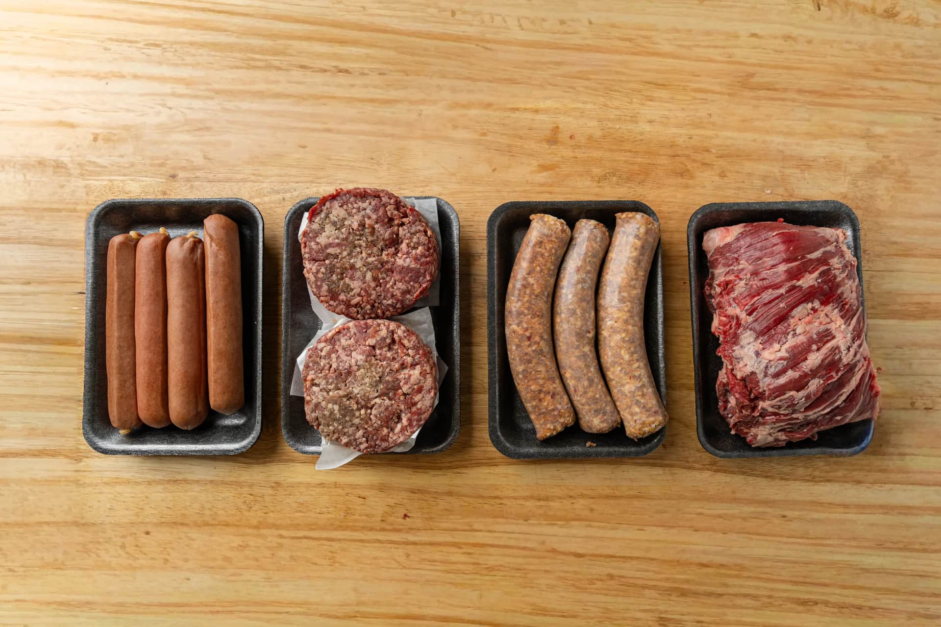 Trays of sausages and prime burgers on the counter